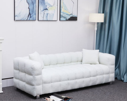 White fabric puffy sofa with two pillows